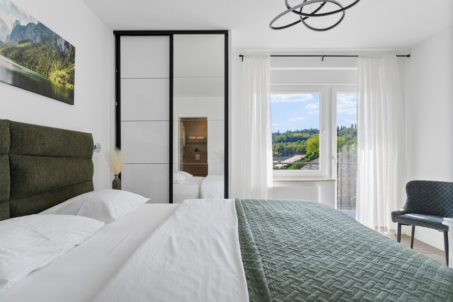 Bedroom 2 is equipped with a King-sized bed (180cm x 200cm), air conditioning, and a shared balcony access.