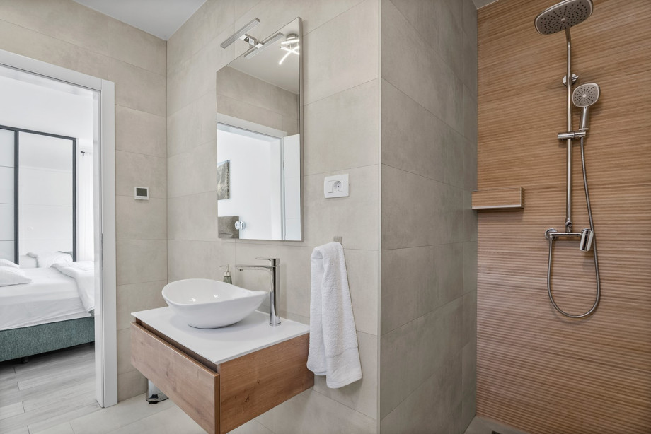 One of the 4 bathrooms in the villa is an en-suite bathroom with a shower, available in both Bedroom 2 and Bedroom 4.