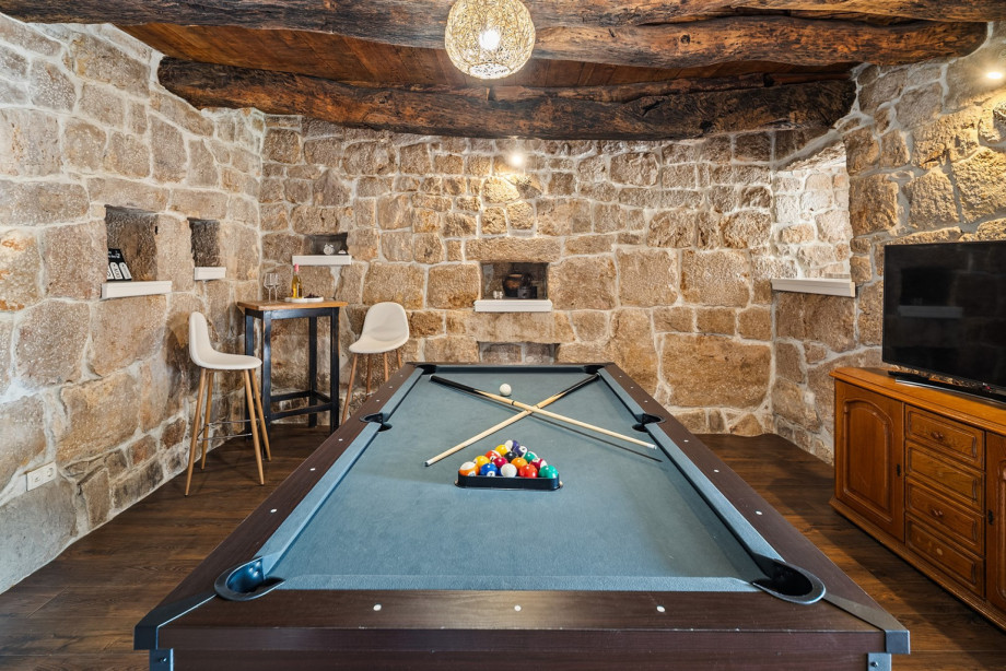 The ground floor's fun zone is a typical Croatian old stone ambience, equipped with a billiard table and a TV.