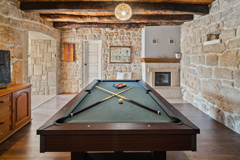 The fun zone on the ground floor is a rustic setting featuring a billiard table for friendly competition and entertainment.
