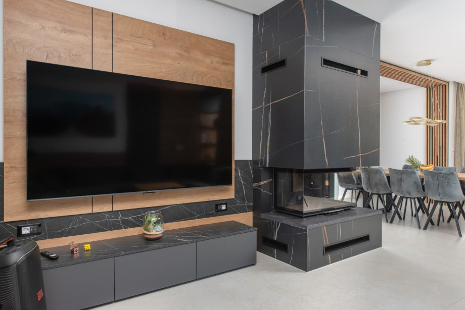 Modern living room featuring a fireplace and a flat-screen TV.
