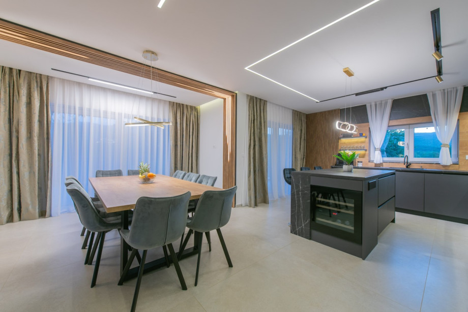 Ground floor living area showing the stylish dining area and fully equipped kitchen.