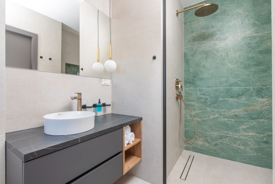 En-suite bathroom with modern design, walk-in shower and elegant finishes.