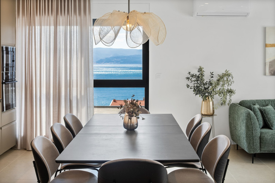 The stylish dining table comfortably seats eight guests for family meals.