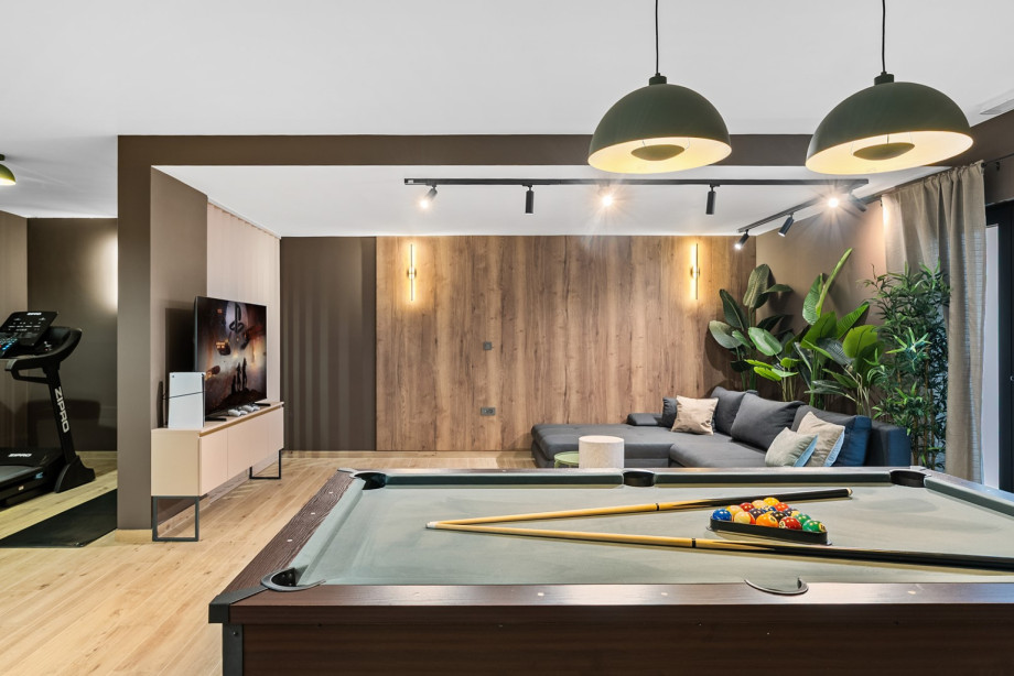 The 55sqm fun-zone includes a pool table, treadmill, and weights for an active stay.