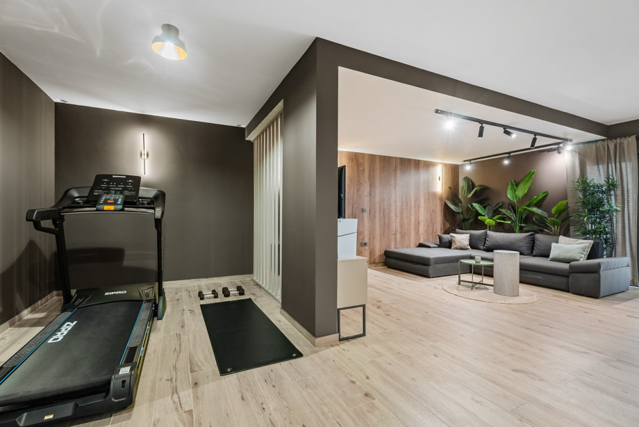 The fitness area includes a treadmill, yoga mat, and weights to stay active during your stay.