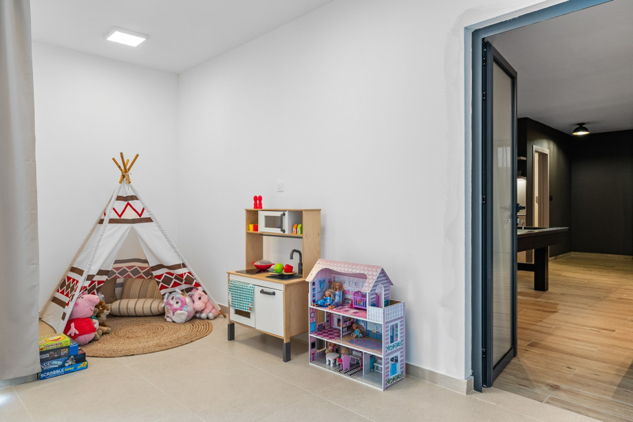 A dedicated kids' corner is filled with toys to keep the youngest family members entertained.