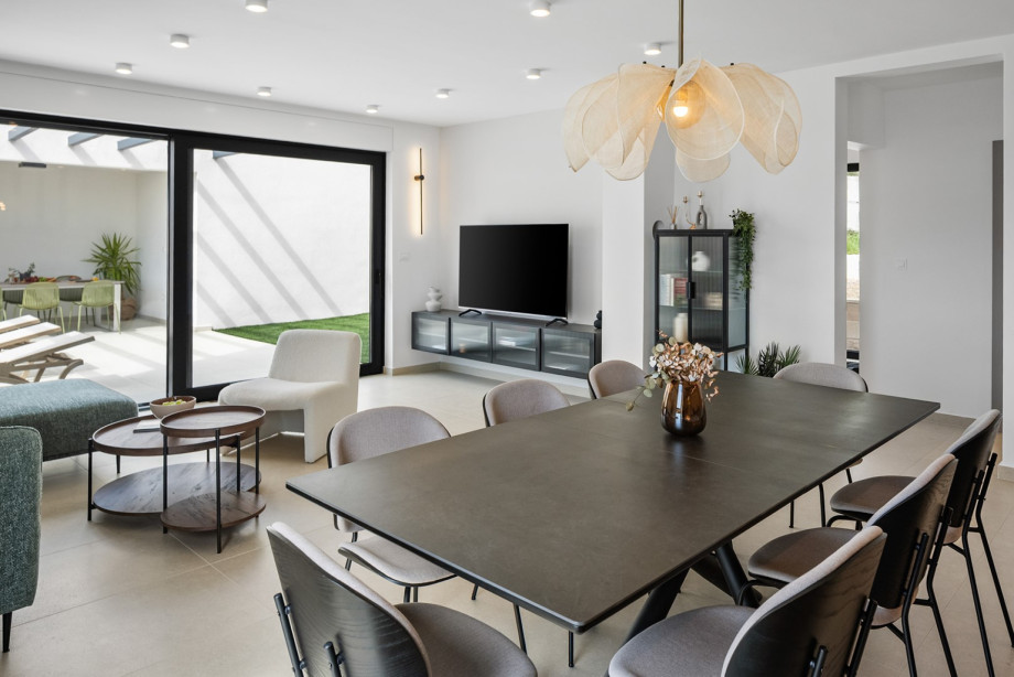Experience a spacious open-plan layout featuring a dining table for eight guests.