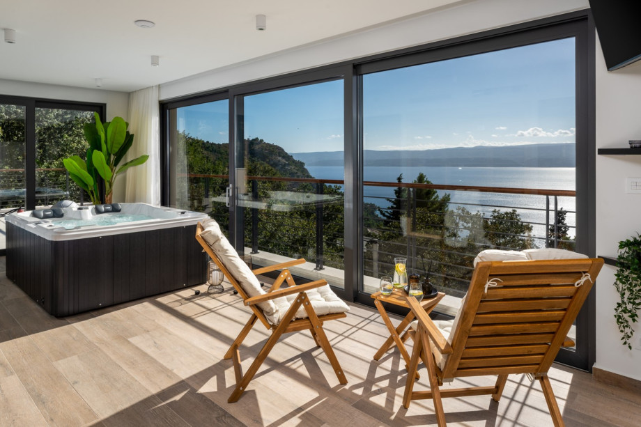 A floor-to-ceiling glass window offers daylight in and a breathtaking view of the Omiš town, sea