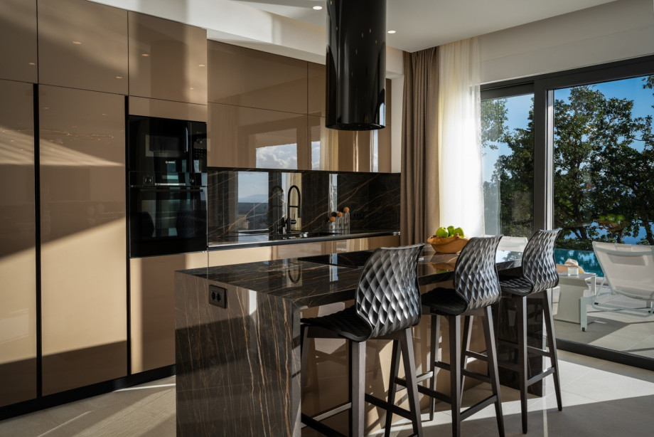 The Ground floor (pool level) offers a fully equipped kitchen with premium appliances