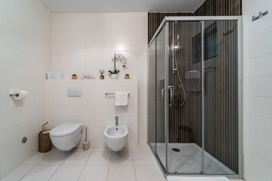 Family bathroom with a shower and washing machine