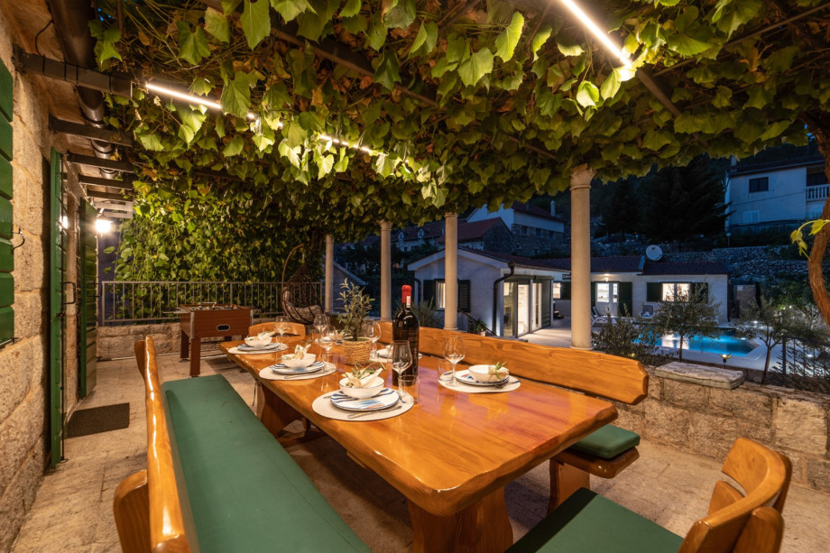 From the stone house you have a lovely naturally shaded outdoor terrace with wooden dining table