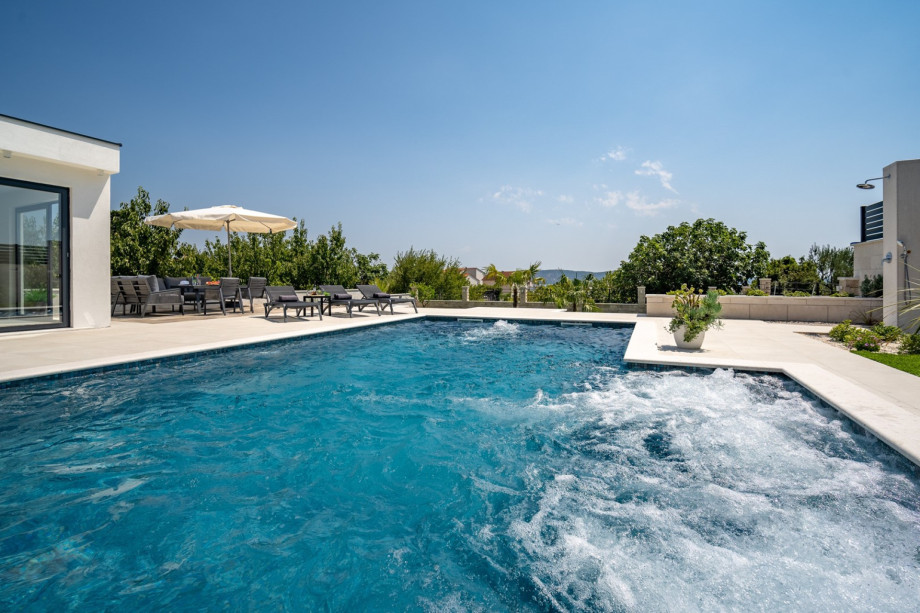 The pool size itself is 11m x 4.25m, plus a hydromassage area with a sitting area 3.5m x 1.2m