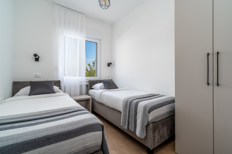 A Bedroom No2 (9sqm) with two single beds 80cm x 200cm, A/C, views of nature