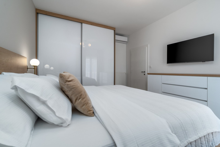 A Bedroom No3 (16sqm) with a king size bed 180cm x 200cm, A/C, TV, and views of nature.