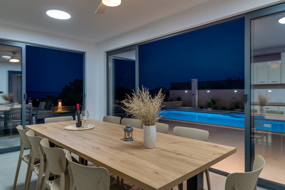 he spacious sun-deck area spreads on two levels, around the pool and a few steps below on the grassplot