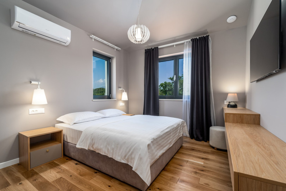 The first floor offers a Bedroom No2 with a queen size bed 160cm x 200cm, air-conditioning, a TV, en-suite bathroom with a shower