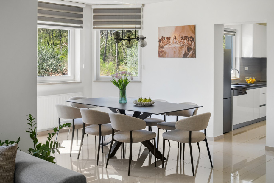 The dining table sits adjacent to the fully equipped kitchen.