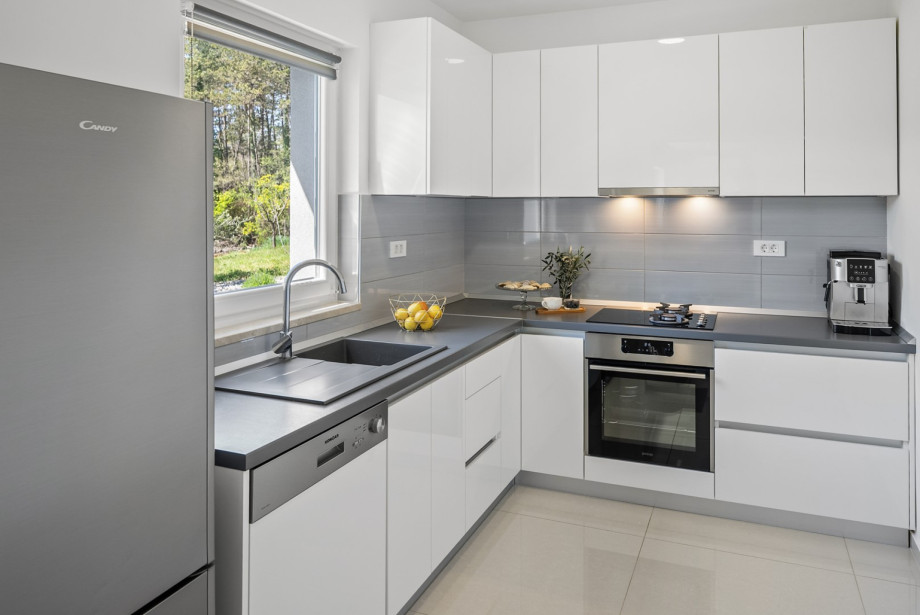 A modern kitchen is fully equipped with high-end appliances.