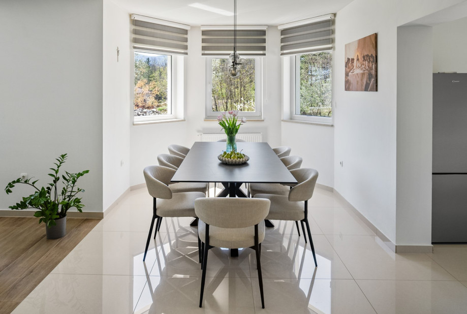 Elegant dining area features a sleek table and seating for indoor meals.