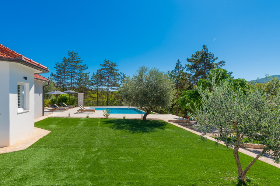 Lush green serenity surrounds the villa on a private plot.