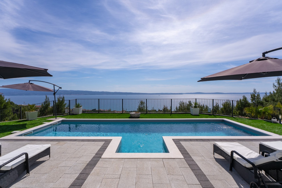 Surrounded by eight sun loungers, umbrellas, and a sea-facing terrace covered with artificial grass for added comfort