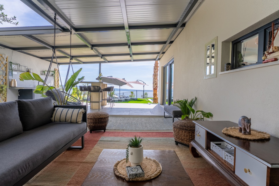 A spacious, seaview terrace where the shaded lounge area opens up to a breathtaking horizon.