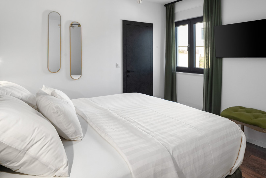 En-suite with shower, a TV, views of the natural surroundings