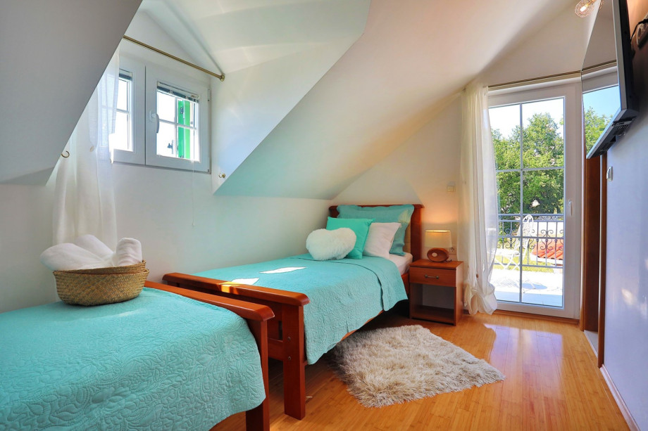 Bedroom No.4. two single beds, TV, and  bathroom en-suite with shower, terrace (west)