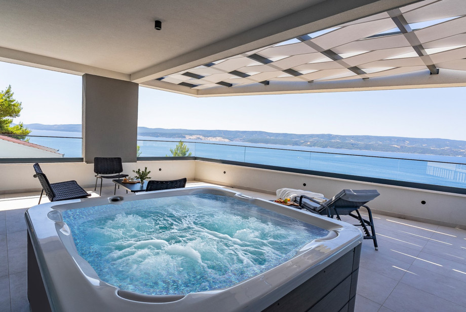 Relax in the welcoming hot tub or bask in the sun on the expansive sun deck