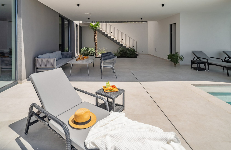 A sun deck, furnished with six loungers, an outdoor shower, and a comfortable lounge area for unwinding