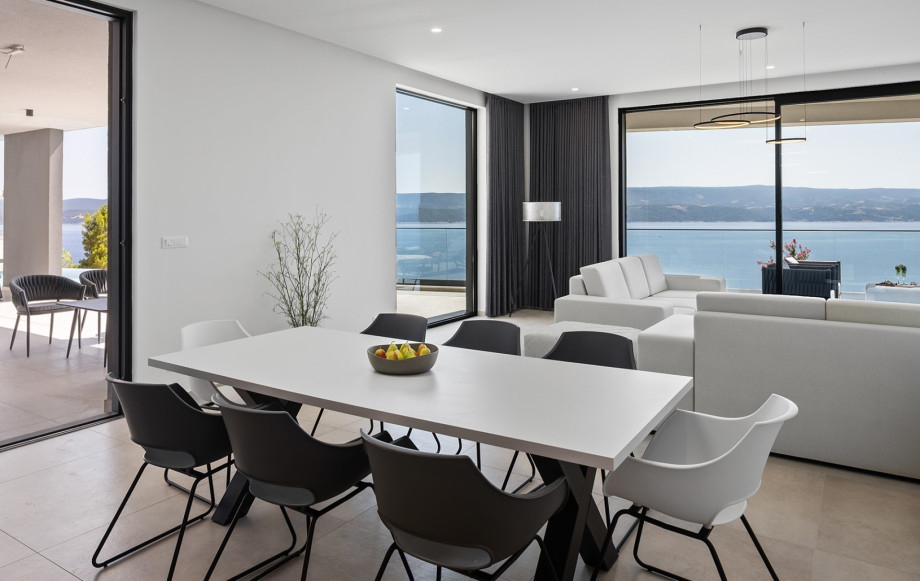 A large dining table that comfortably seats 8, ideal for family meals or enjoying the fresh local produce