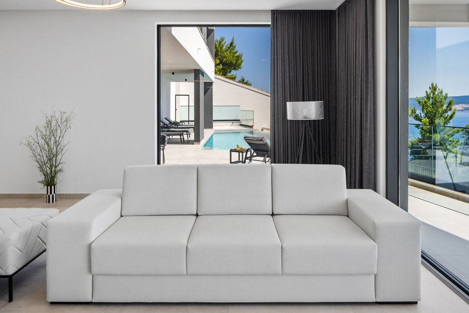 The ground floor offers a stylish open-plan living room, dining area, and fully equipped kitchen