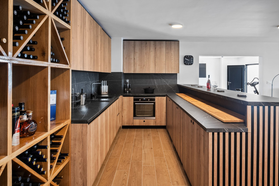 Kitchen No.2 (including a refrigerator, wine cooler, ice maker, four-burner electric stove, popcorn maker, coffee machine, and dishwasher), along with a dining table