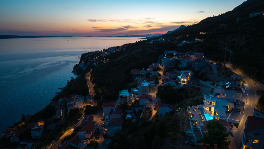 The tranquil surroundings effortlessly blend indoor and outdoor living, allowing for seamless gatherings and unforgettable moments