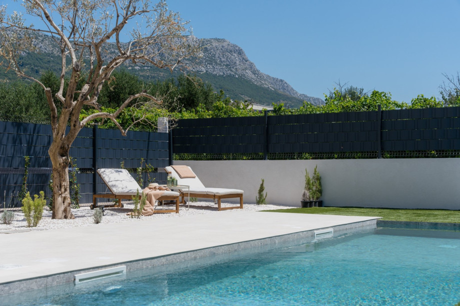 The sun deck area features six sundeck chairs, an outdoor shower
