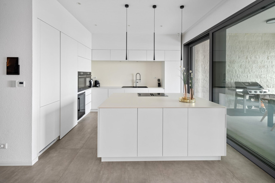 Two ovens (one is a combo with a microwave), a wine cooler, a fridge, and a dishwasher.