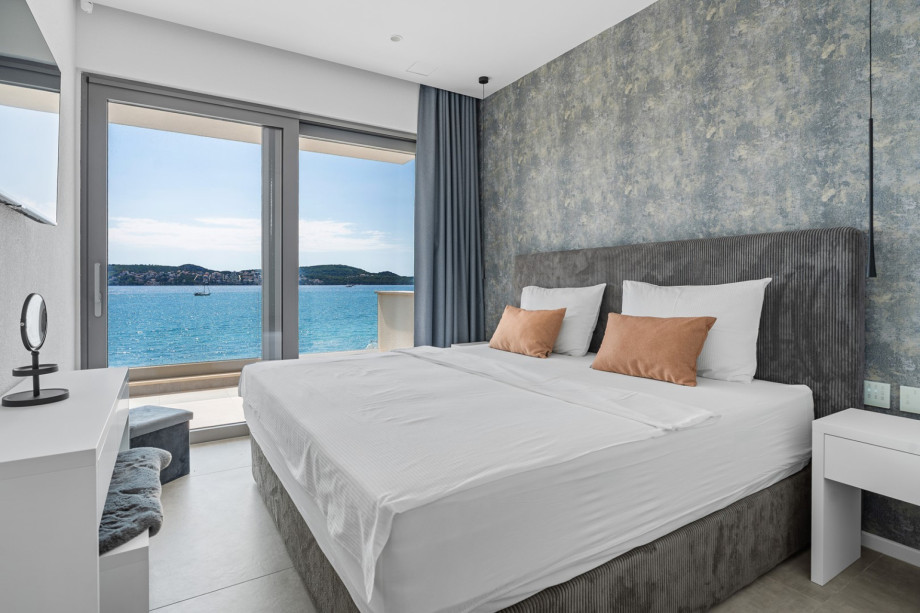 Bedroom 2, with a shared balcony.