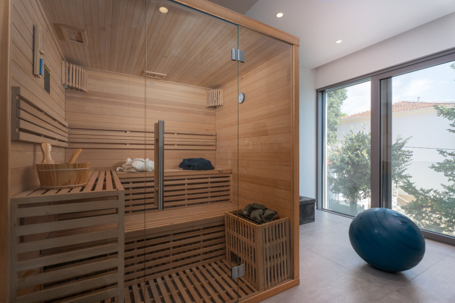 The first floor features a Finnish Sauna room with fitness equipment