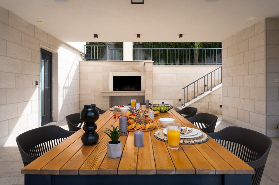 Outdoor, covered dining area connected with pool area