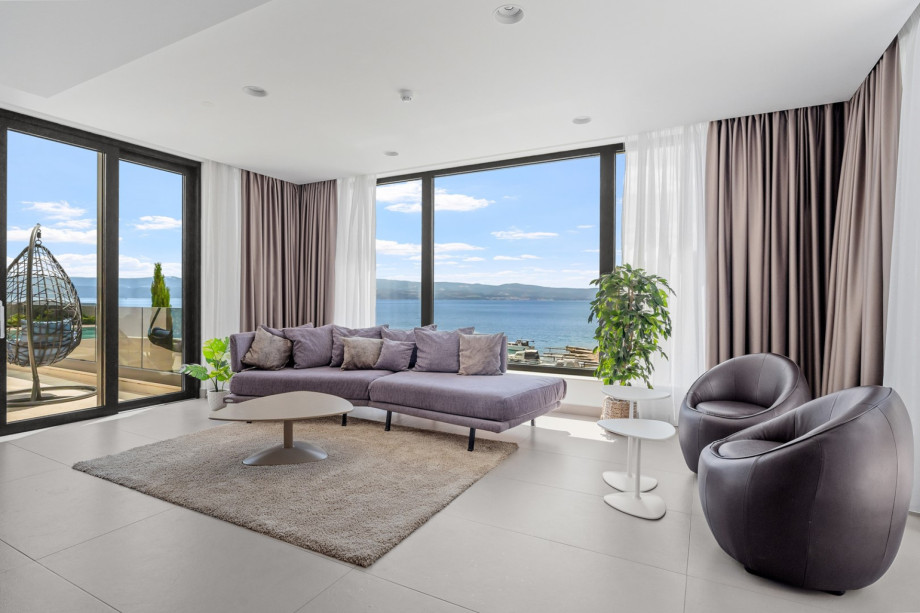 Living and dining area with  sea views, fire place, TV, exit to outdoor dining