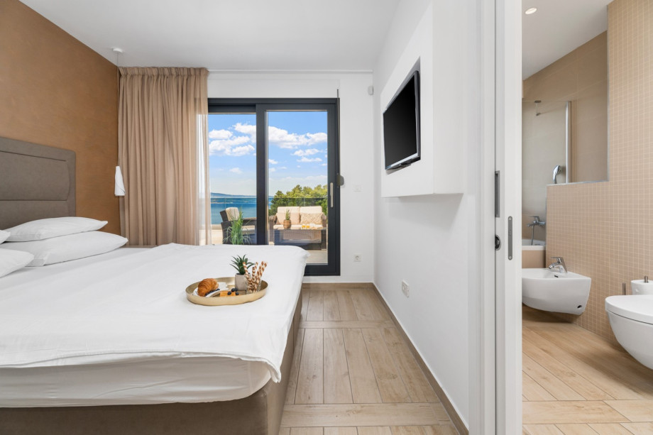 One of 2 bedrooms with king size bed 180x210cm, en-suite bathroom, TV, exit to terrace