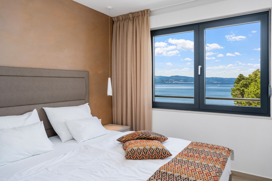 One of 2 bedrooms with king size bed 180x210cm, en-suite bathroom, TV, exit to terrace