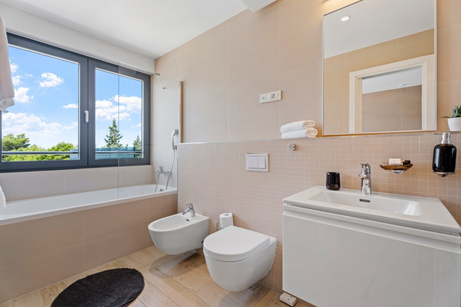 One of 4 en-suite bathrooms with bathtub, shower, bidet and sea views