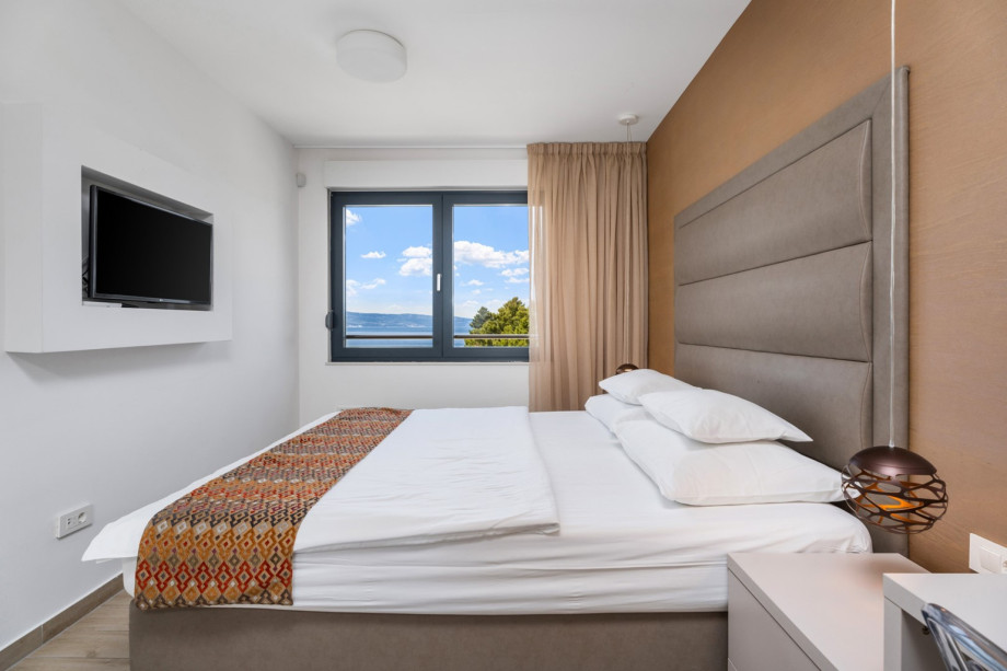 One of 4 bedrooms with double bed 180x210cm, en-suite bathroom, TV and sofa bed