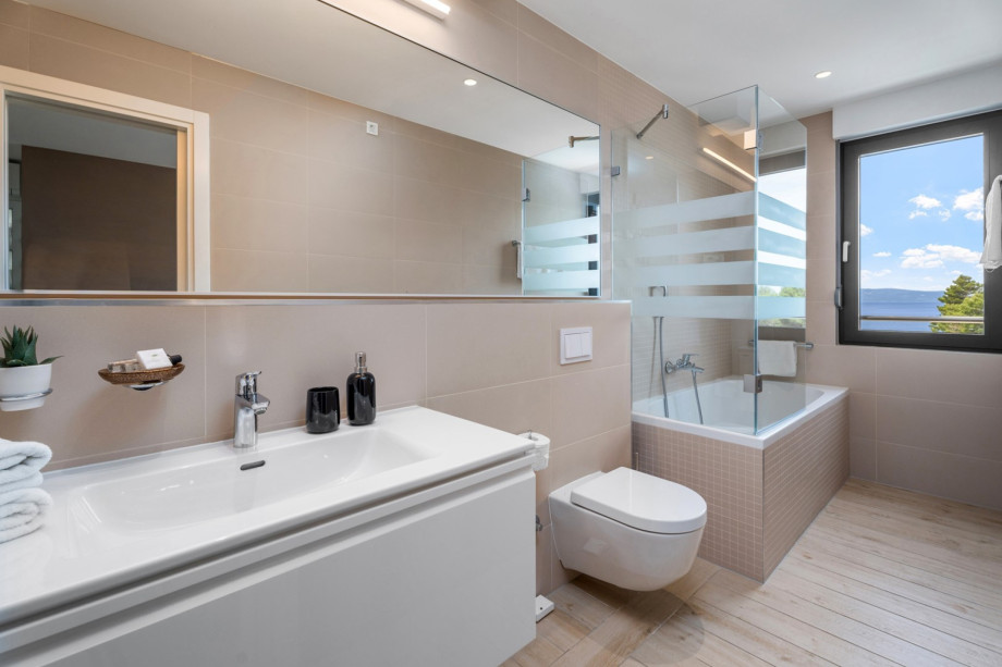 One of 4 en-suite bathrooms with bathtub, shower, bidet and sea views