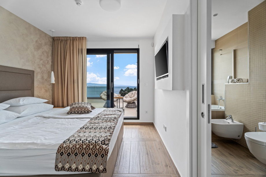 1 of 2 bedrooms that have exit to spacious terrace with comfortable furniture