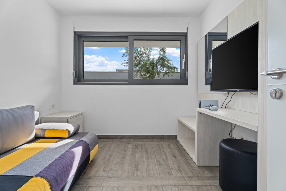 Small bedroom No5 with sofa bed and TV, at gym level