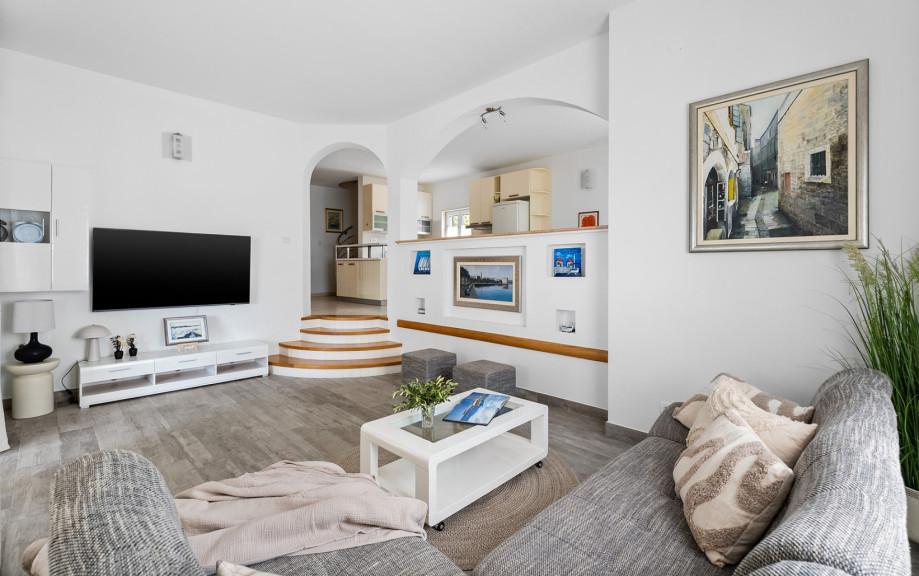 This air-conditioned living area features sofas, a TV, and a PlayStation 4 for guest entertainment.