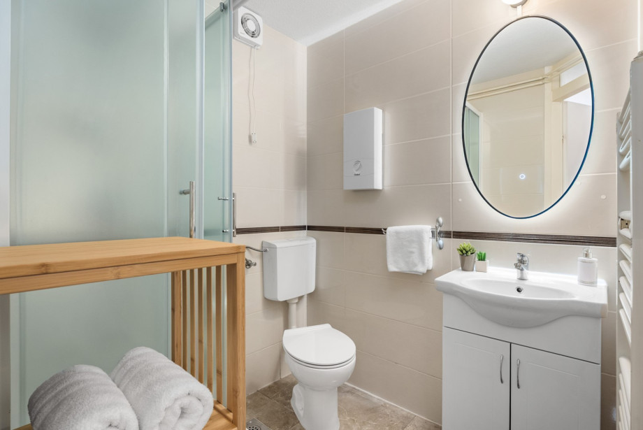 The bathroom with a shower is located within the private apartment area.
